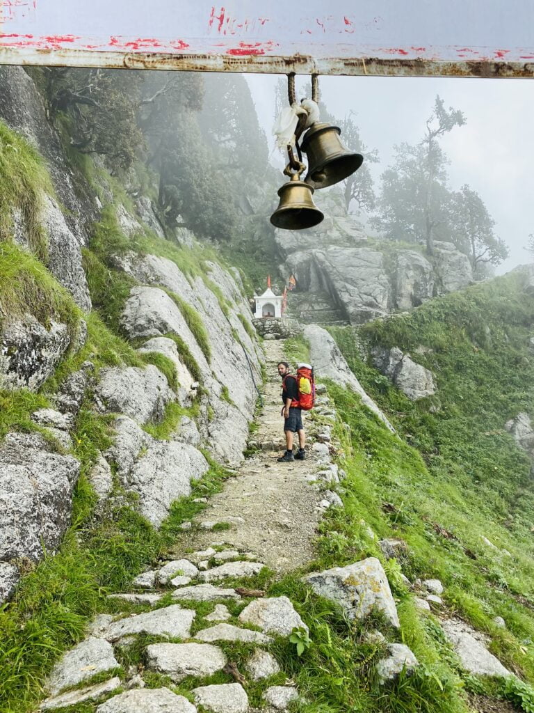 Temple bells above a stone trail in the Dhauladhar mountains