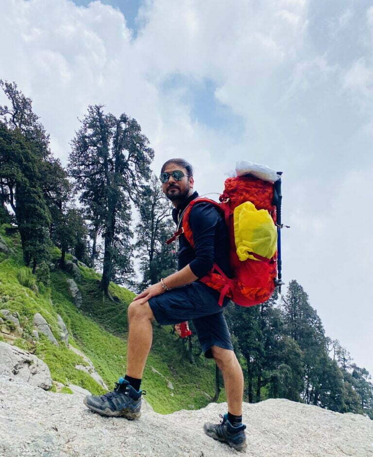 a man with a backpack on a rocky hill