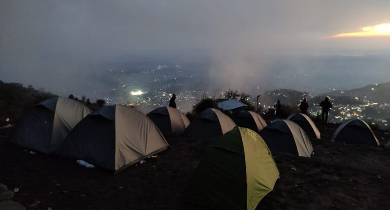 Leta Camp on the Triund trek with camping tents overlooking the Kangra Valley lights near Dharamshala, Himachal Pradesh