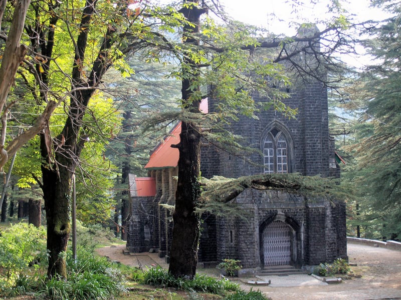 a stone building with trees in the background