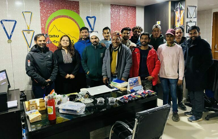 a group of people standing in a office, Manu Adventures India Team