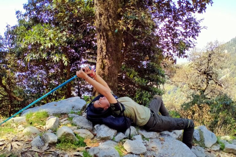 Triund Day Hike from McLeod Ganj 6 Hiker resting on a rock with mountain views near Triund
