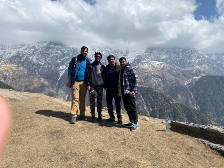 Triund Day Hike from McLeod Ganj 5 Trekking group at Triund with snow-covered mountains behind them