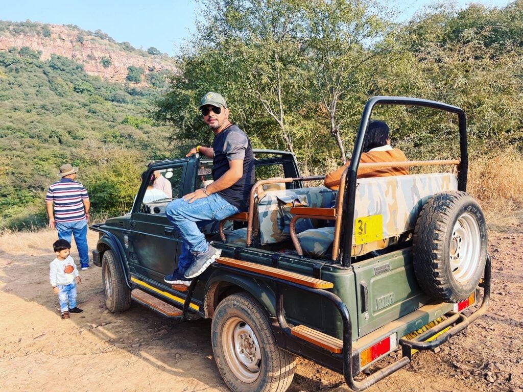 Golden Triangle Tour with Ranthambore Safari 3 Travelers enjoying a jungle jeep safari through forest terrain in India