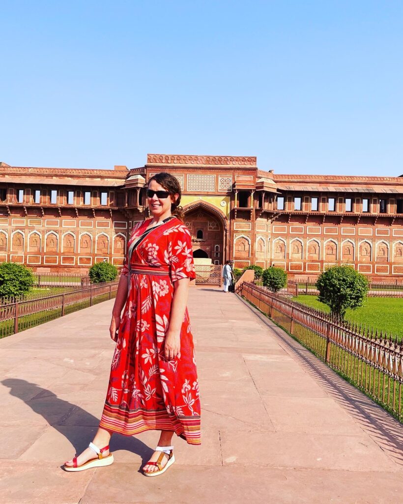 Traveler standing inside Agra Fort showcasing historic red sandstone Mughal architecture in Agra