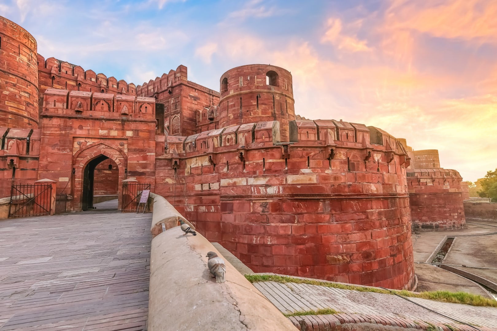 Historic medieval Agra Fort made of red sandstone at sunrise with moody sky. Agra Fort is a UNESCO World Heritage site