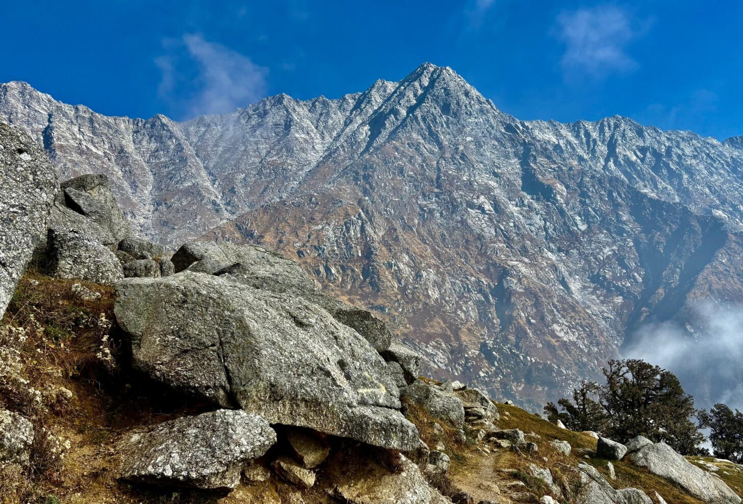 Rocky trail with dramatic Dhauladhar mountain range near Dharamshala, Himachal Pradesh