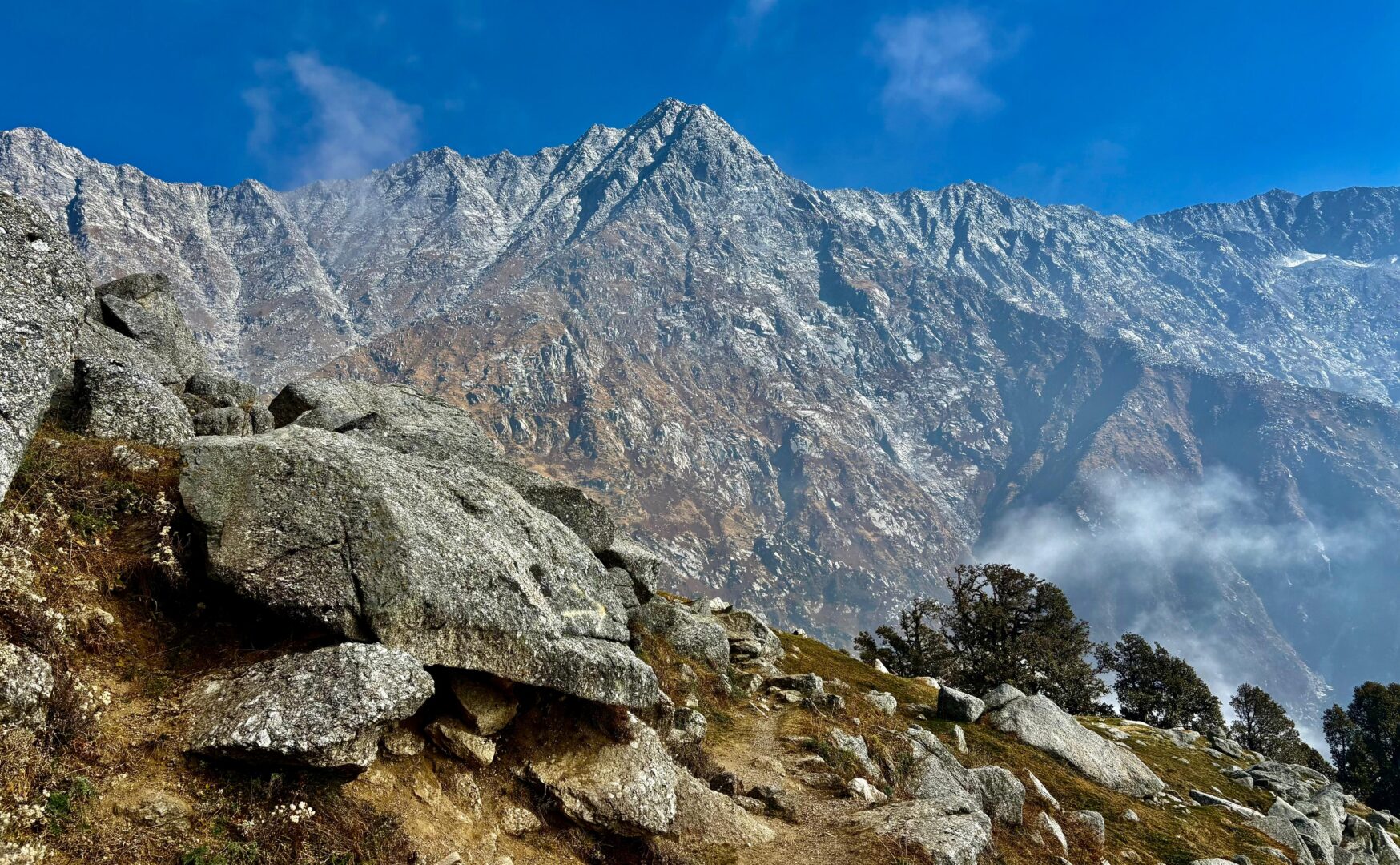 Rocky trail with dramatic Dhauladhar mountain range near Dharamshala, Himachal Pradesh