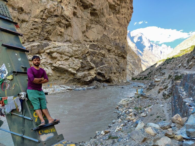 Traveller beside a river gorge on the Spiti road journey