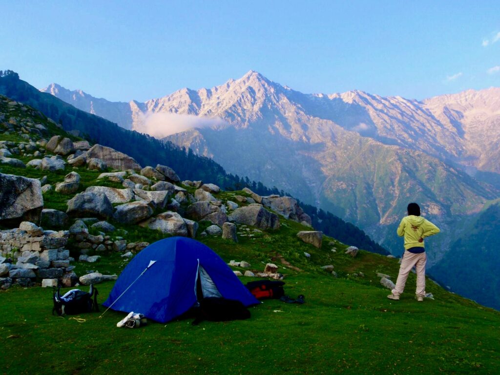 Camping tent with majestic mountain views in Himachal Pradesh during a trek.