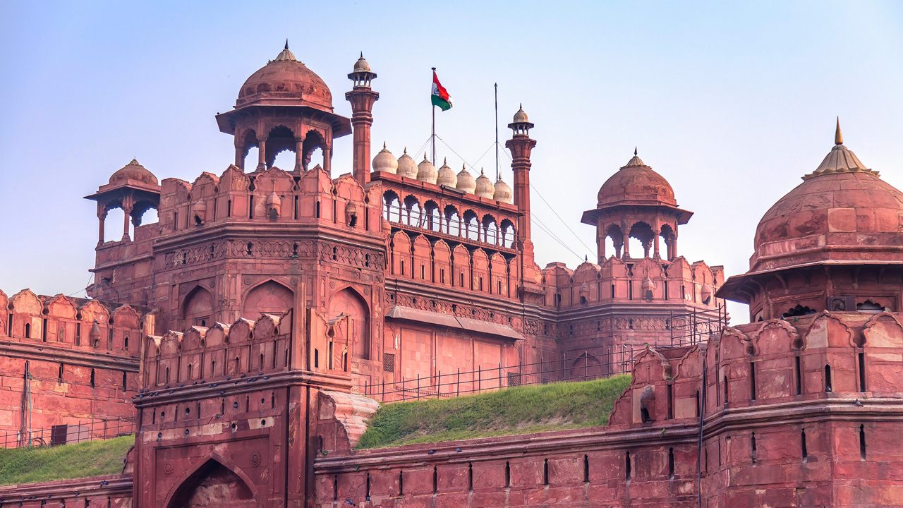 Historic Red Fort in Delhi built with red sandstone, Indian flag flying above