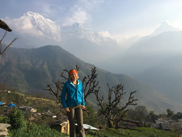 Solo trekker enjoying quiet independence on a Himalayan trail overlooking mountain villages, illustrating freedom with safety and guided support for solo travelers in India.