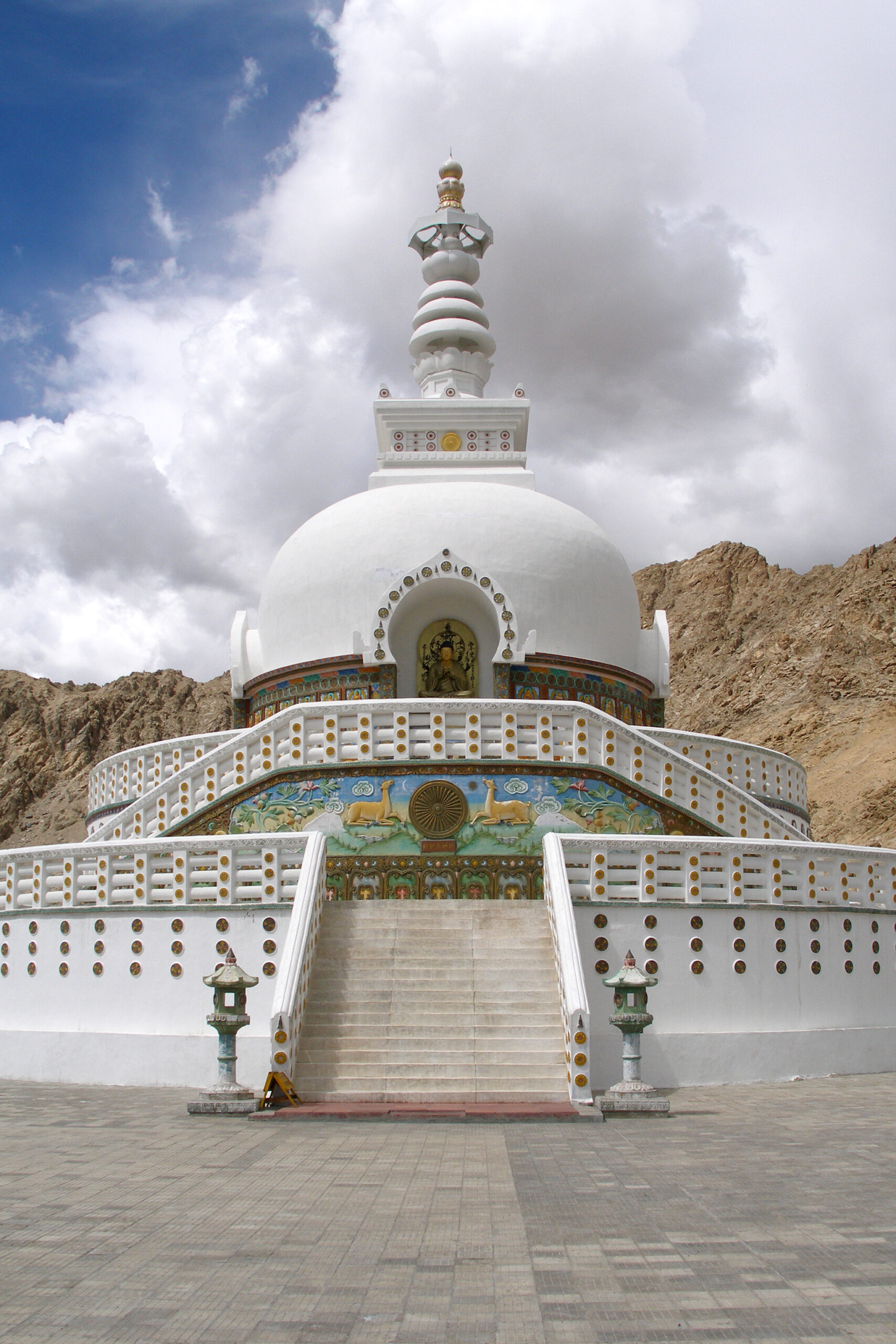 Shanti Stupa in Leh with dramatic cloudy sky and Himalayan mountains in the background