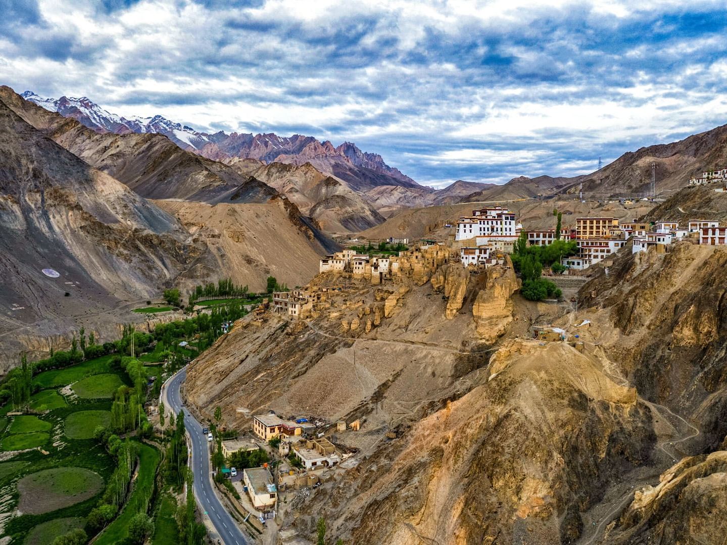 Aerial view of Lamayuru Monastery surrounded by dramatic mountain landscape in Ladakh