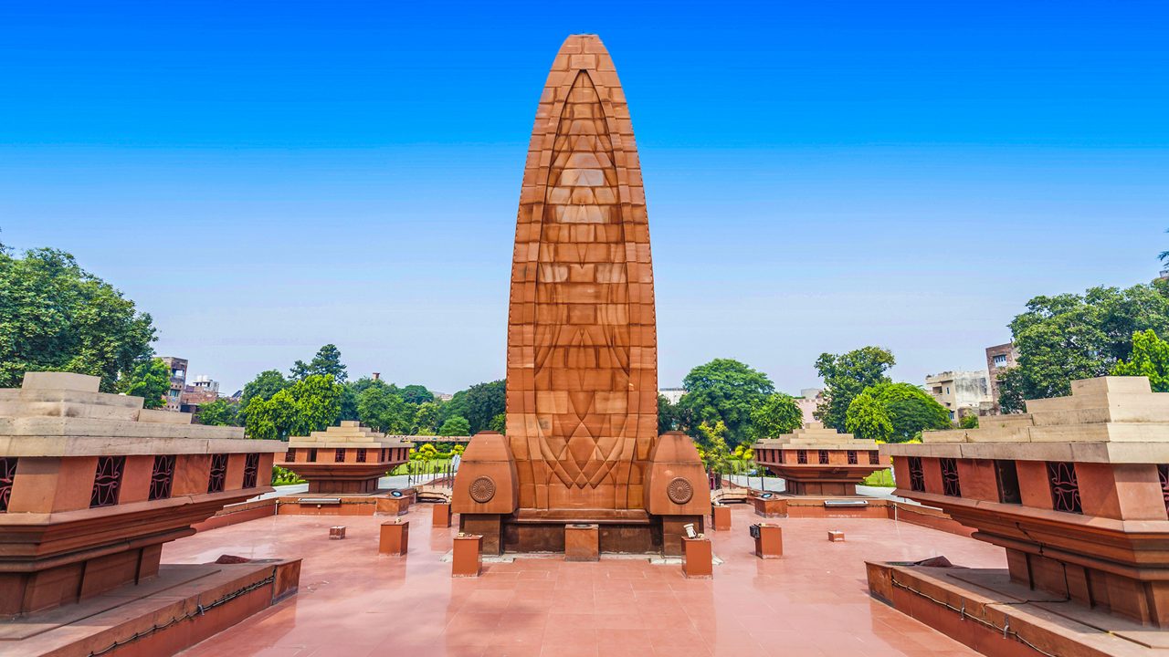 Jallianwala Bagh memorial monument in Amritsar with clear blue sky and surrounding gardens