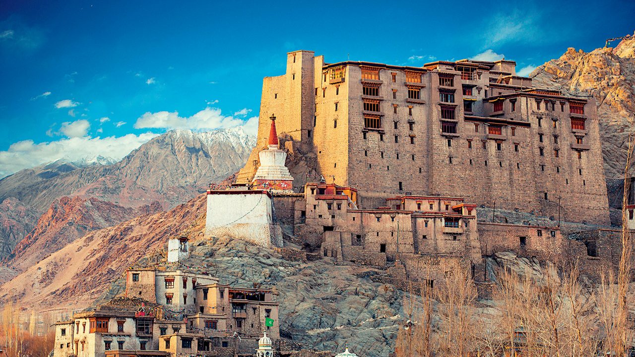 eh Palace overlooking the old town with rugged Himalayan mountains in the background