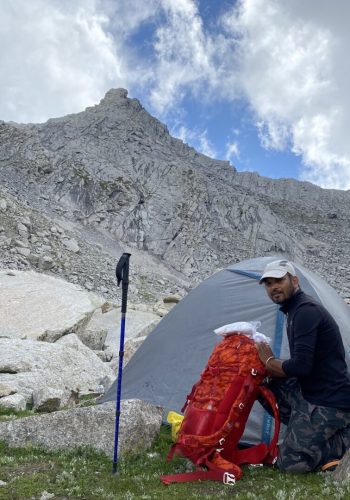 a man standing next to a tent