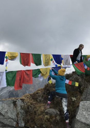 a group of people on a rope with flags